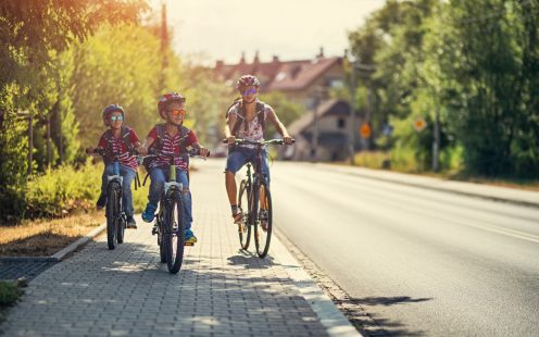 Three kids riding bikes to school.
Nikon D850