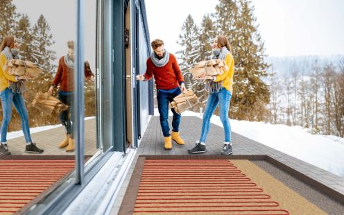 Happy manual worker welcoming young couple to their renovated apartment.